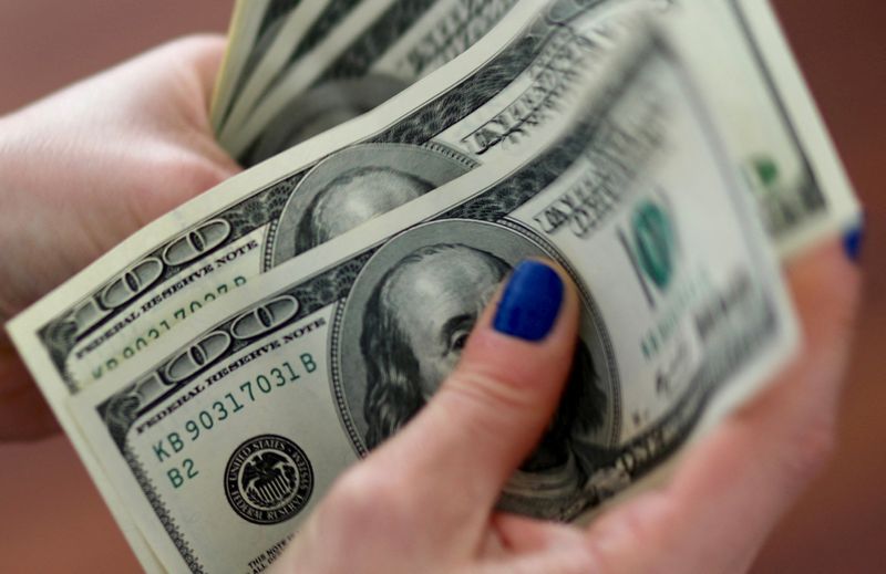 Dollar holds gains against sterling, yen as central bank decisions loom