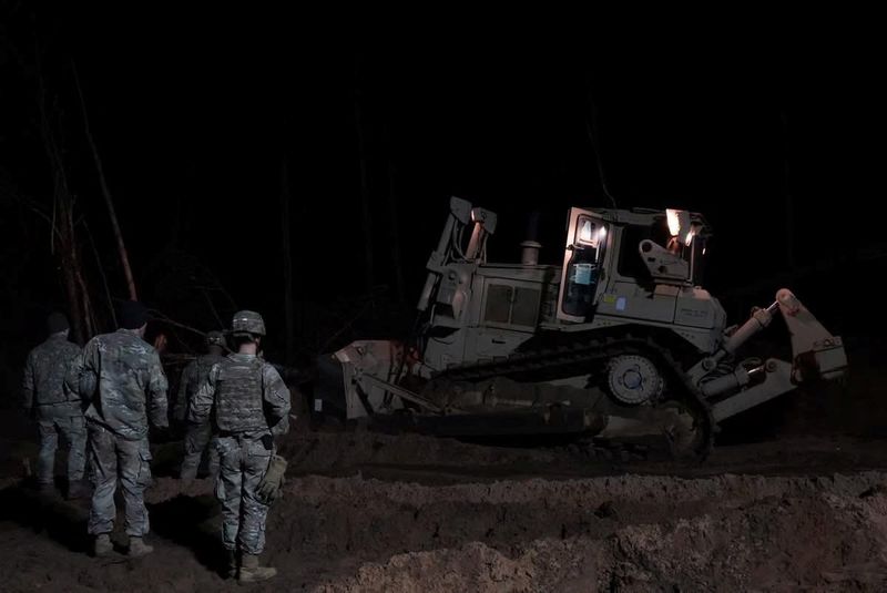 Rescuers dig for missing U.S. soldiers' vehicle in Lithuania