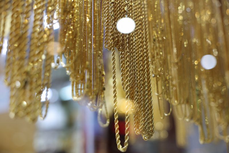 Gold holds near record peak as investors await Trump tariff plan