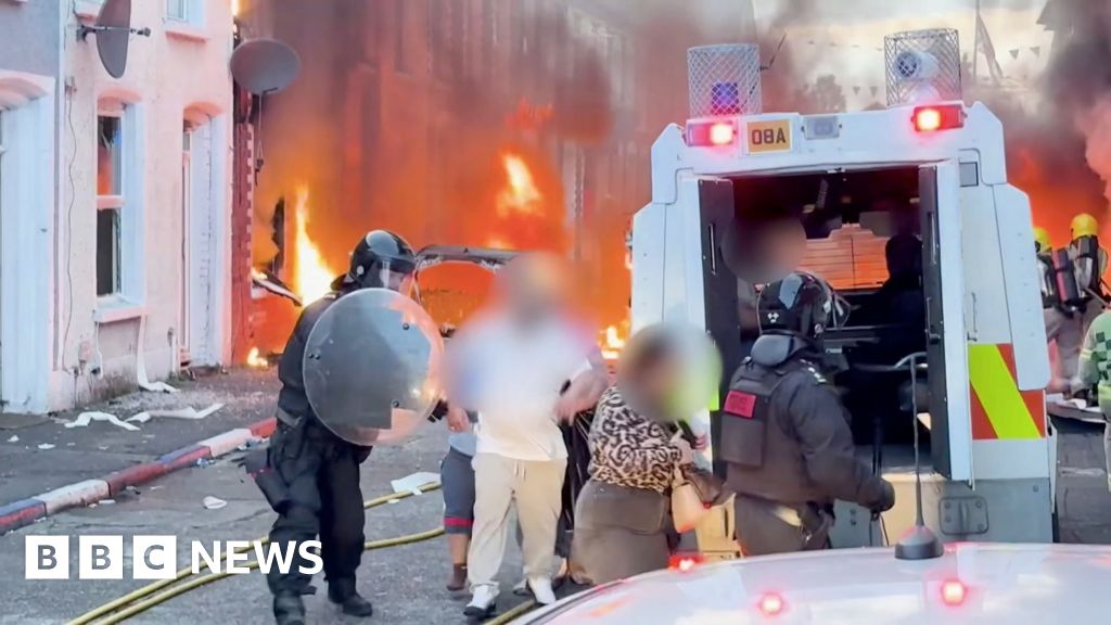 Watch: Residents flee as cars and houses burn in Belfast