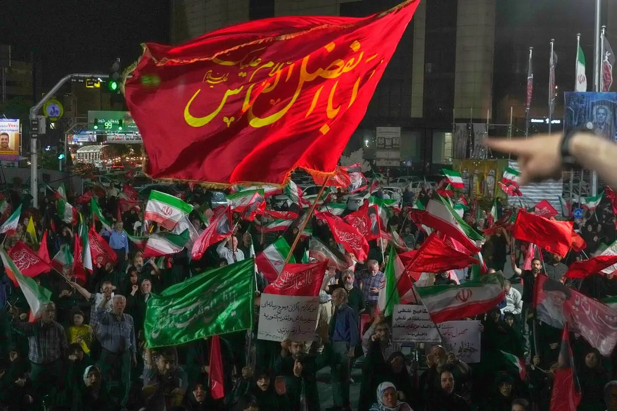 Iran says it is suspending commitments to interim deal with US as the two exchange attacks